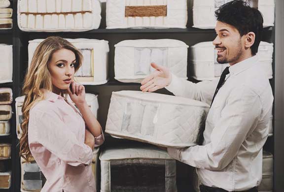 Salesman Explaining Mattress Features