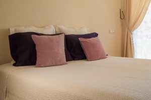 Cozy bedroom with mattress pillows and white bedding