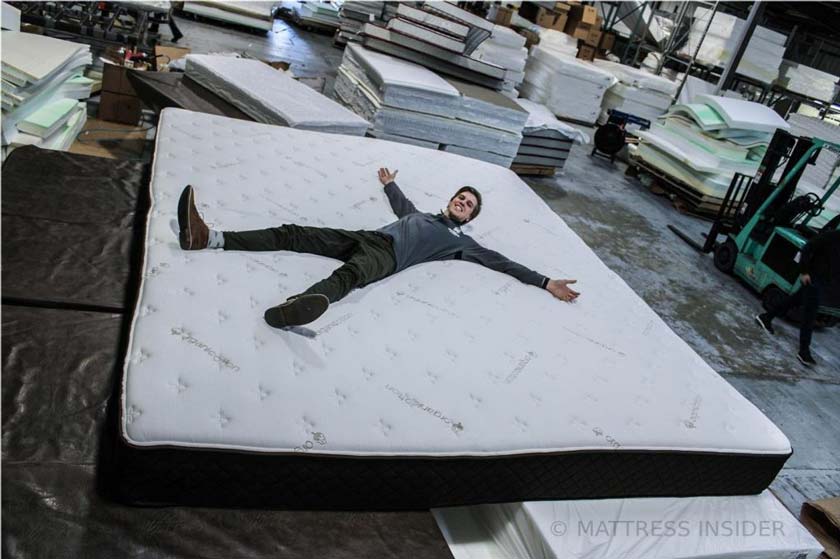 Man on giant Alaskan King mattress