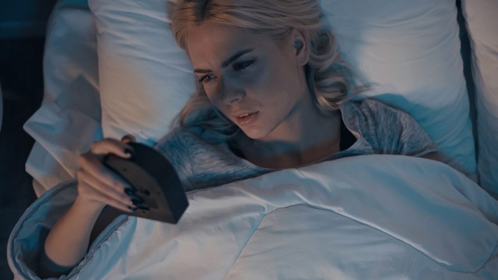 Woman awake in bed with insomnia