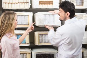 Couple shopping for mattress in store