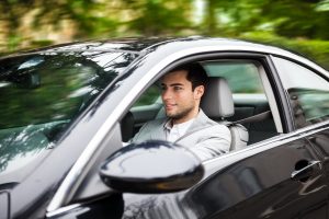 Man staying alert while driving car
