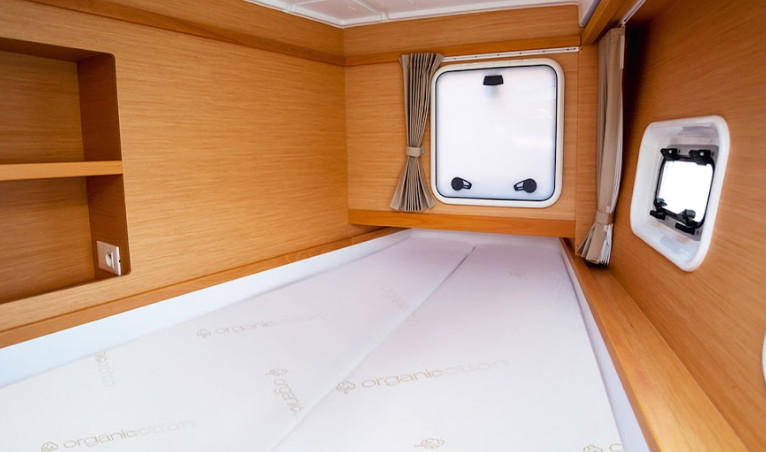 V-berth boat mattress side by side with taper in yacht cabin